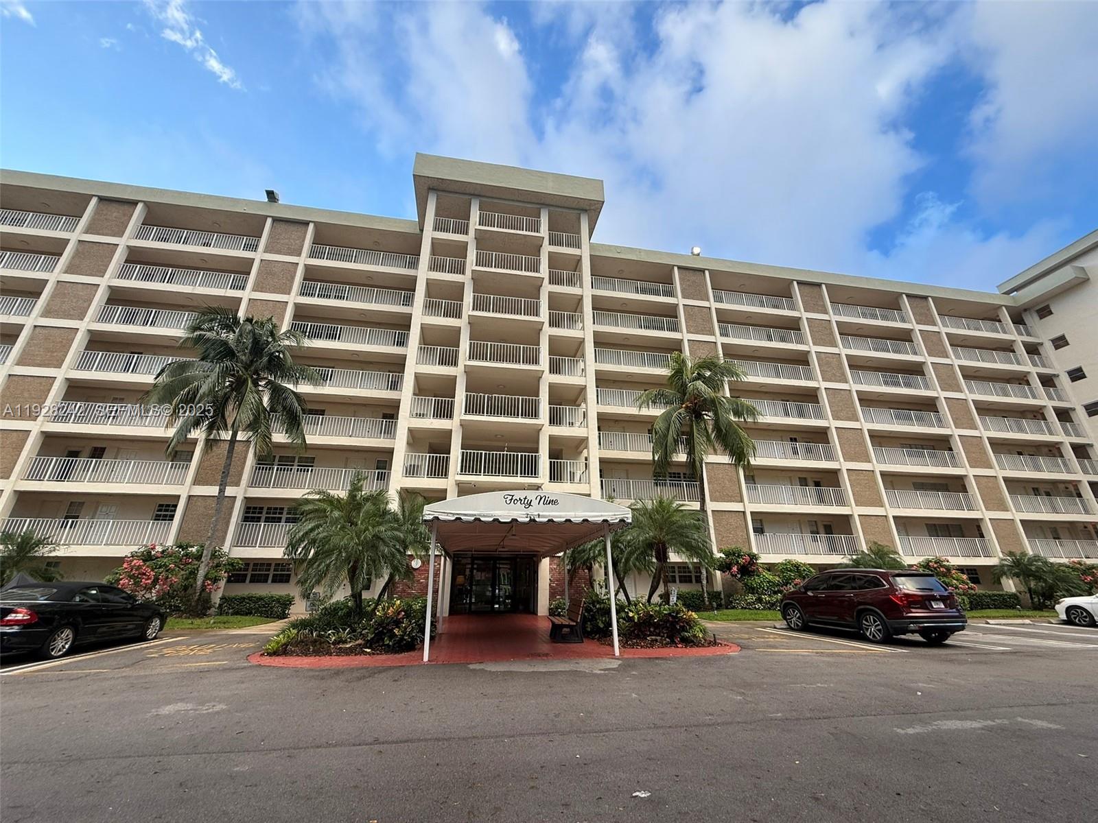 3091 North Course Drive, Unit 705 Pompano Beach, FL 33069 - Photo 1 of 30 front view of a building with a street