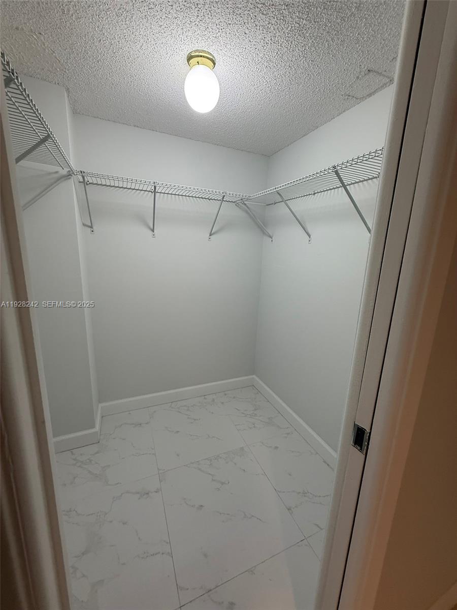 3091 North Course Drive, Unit 705 Pompano Beach, FL 33069 - Photo 13 of 30 a view of a room with racks on the wall