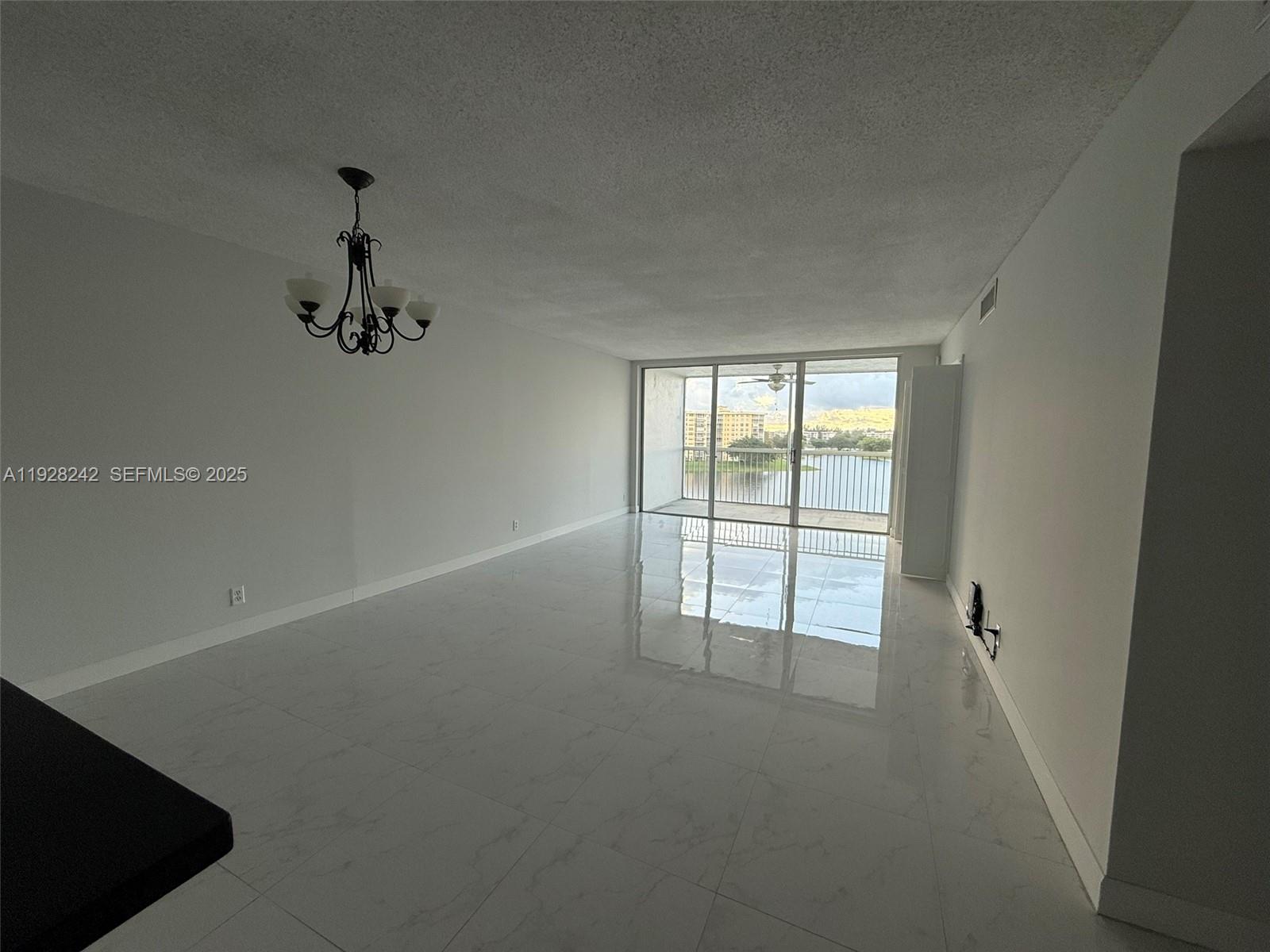 3091 North Course Drive, Unit 705 Pompano Beach, FL 33069 - Photo 16 of 30 an empty room with a empty space and windows