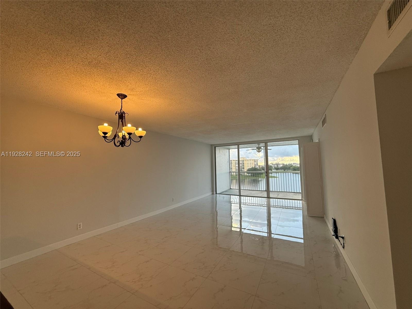 3091 North Course Drive, Unit 705 Pompano Beach, FL 33069 - Photo 17 of 30 wooden floor in an empty room with a window