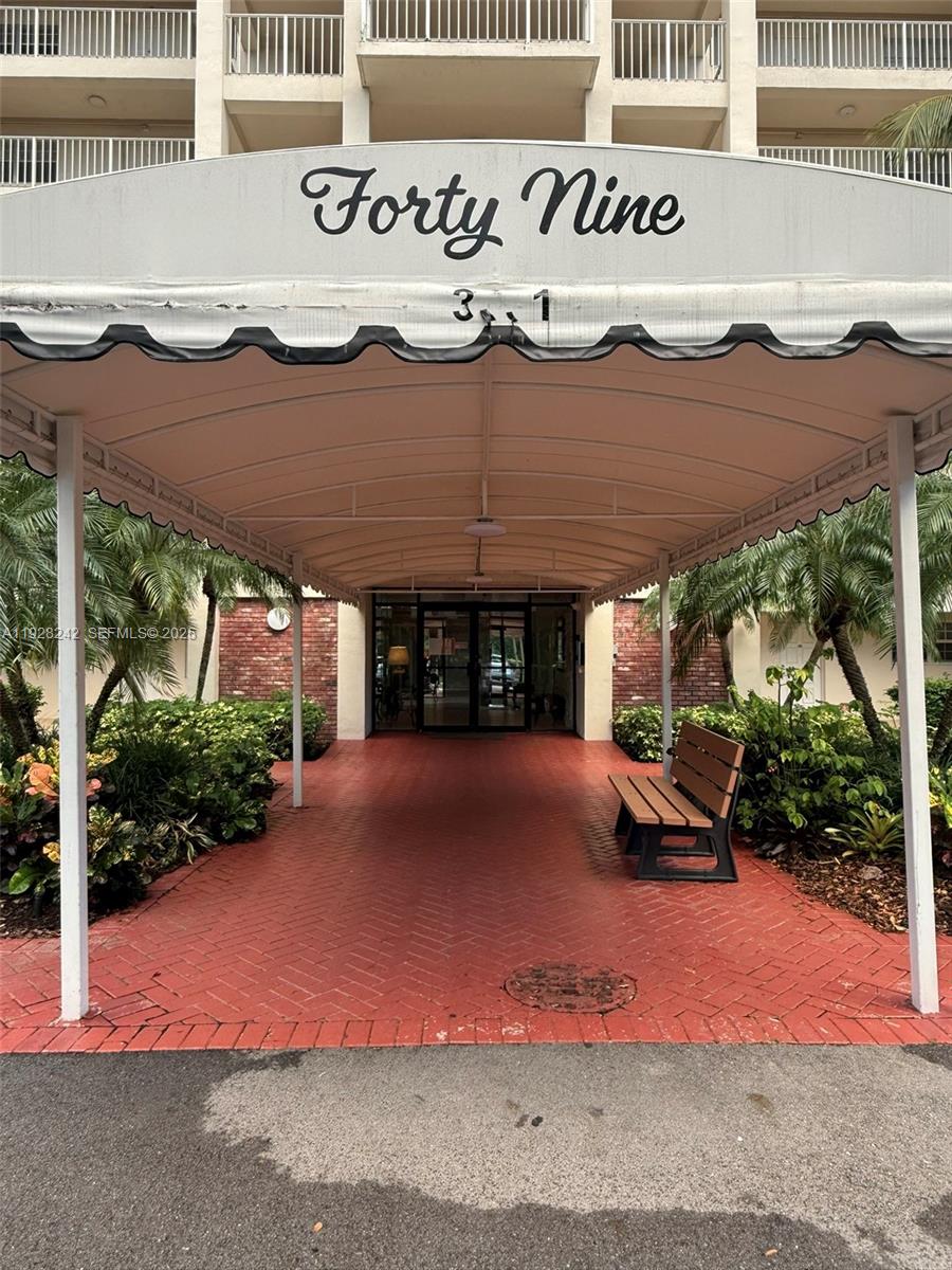 3091 North Course Drive, Unit 705 Pompano Beach, FL 33069 - Photo 2 of 30 a view of a house with backyard and a garage