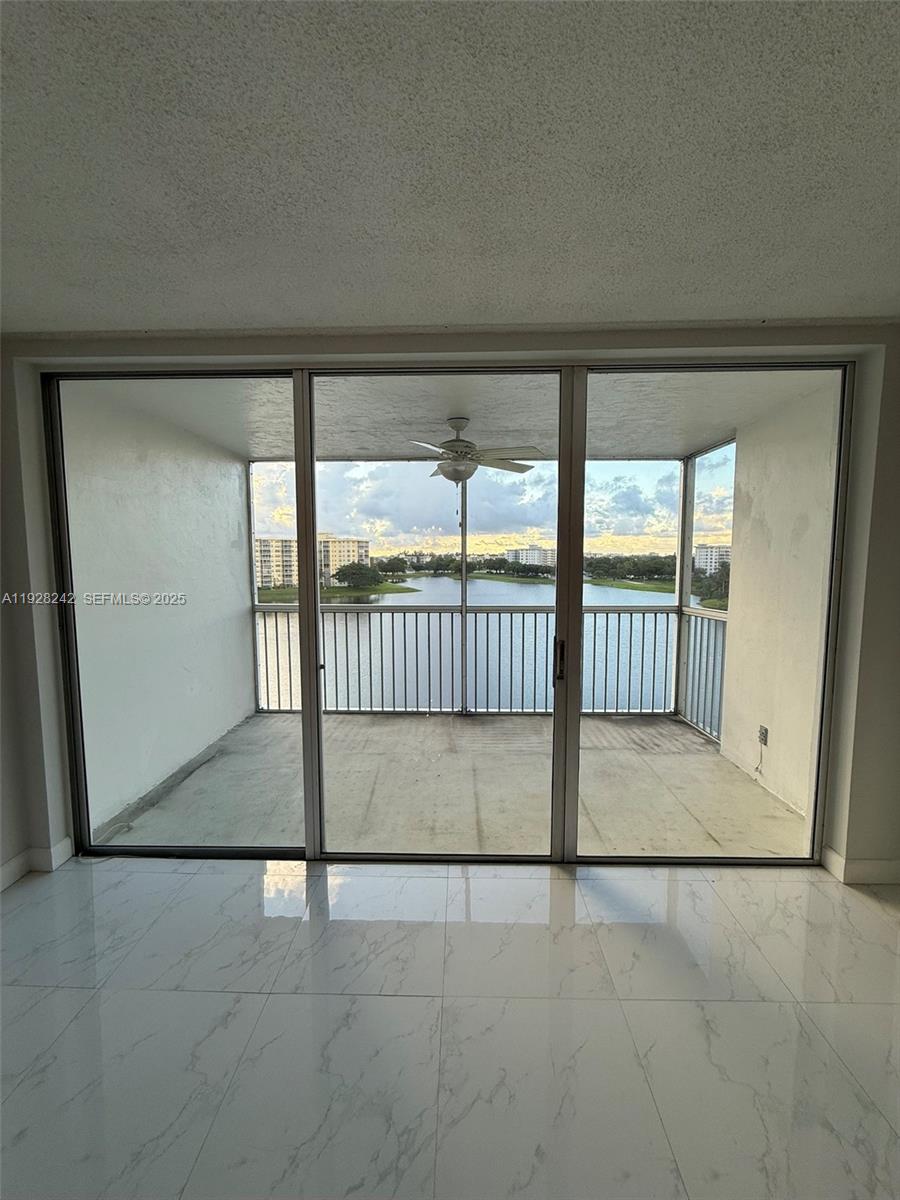 3091 North Course Drive, Unit 705 Pompano Beach, FL 33069 - Photo 23 of 30 an empty room with sliding glass door and door