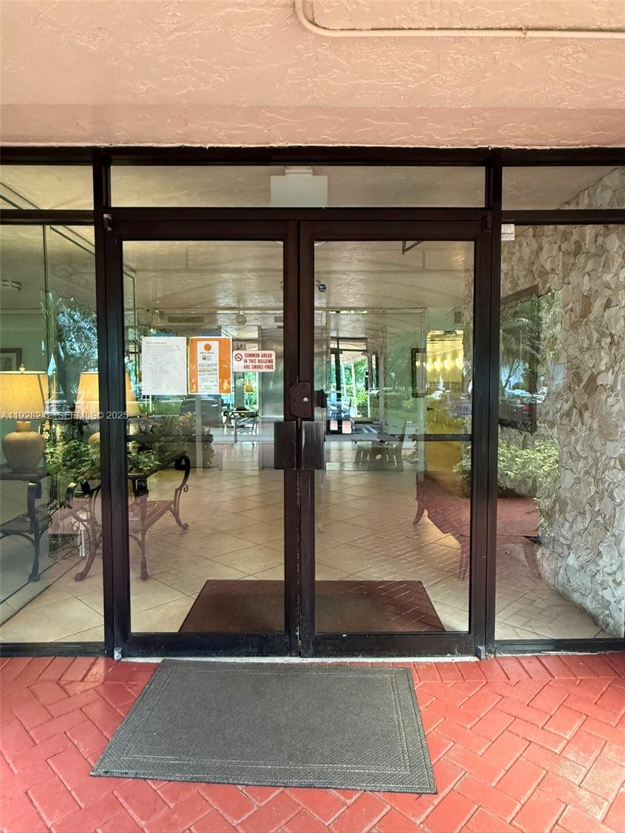 3091 North Course Drive, Unit 705 Pompano Beach, FL 33069 - Photo 4 of 30 a view of lobby with floor to ceiling windows and yard