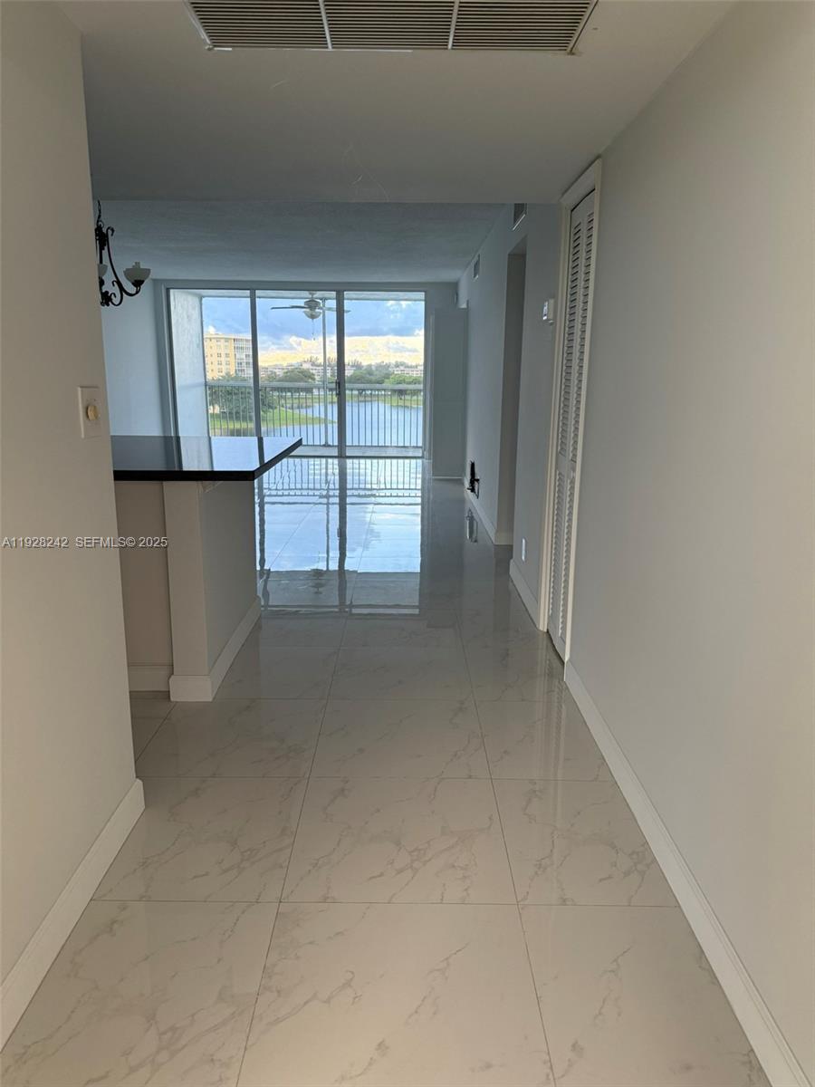 3091 North Course Drive, Unit 705 Pompano Beach, FL 33069 - Photo 9 of 30 a view of an empty room and window