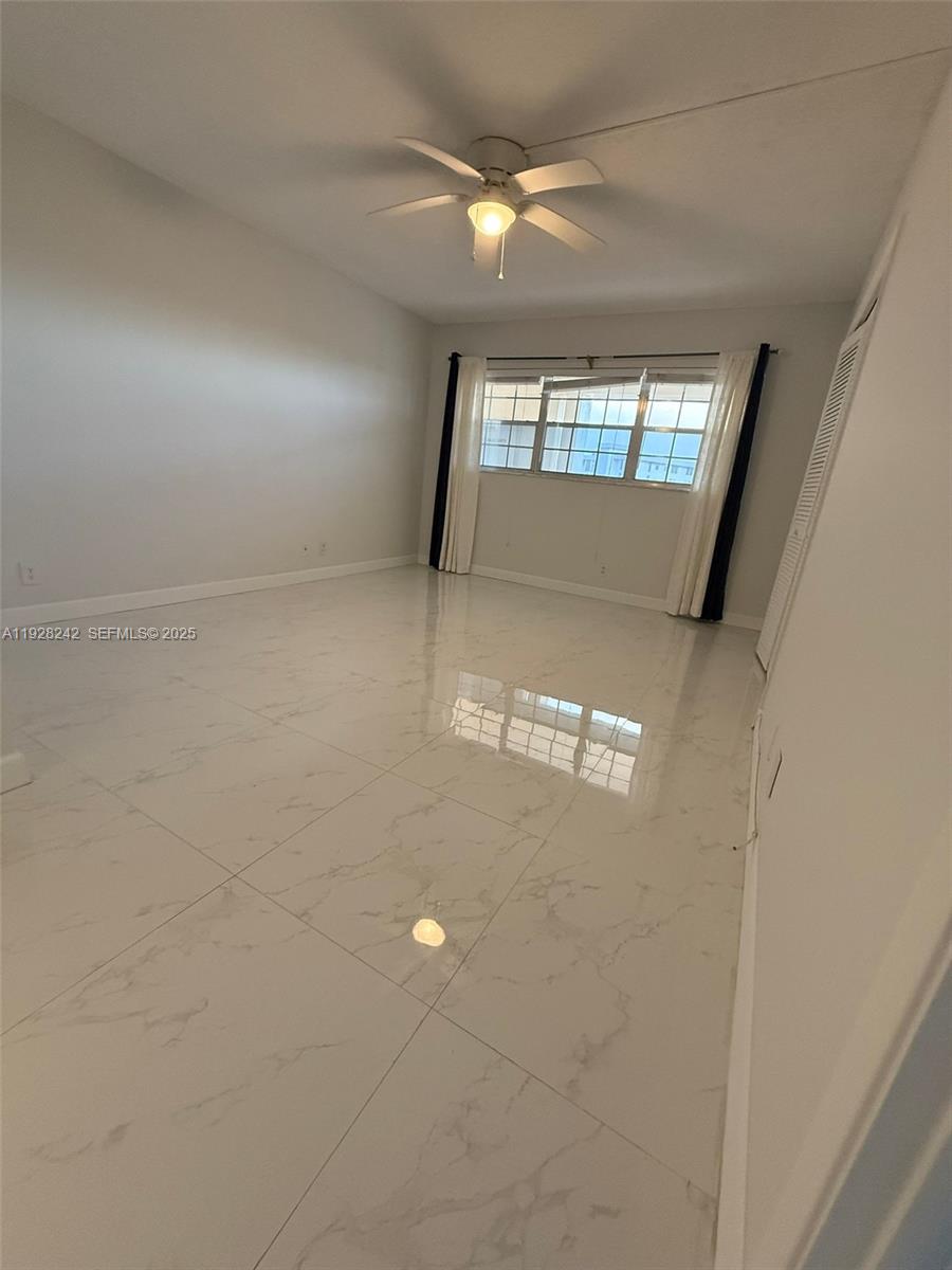 3091 North Course Drive, Unit 705 Pompano Beach, FL 33069 - Photo 10 of 30 a view of an empty room and window