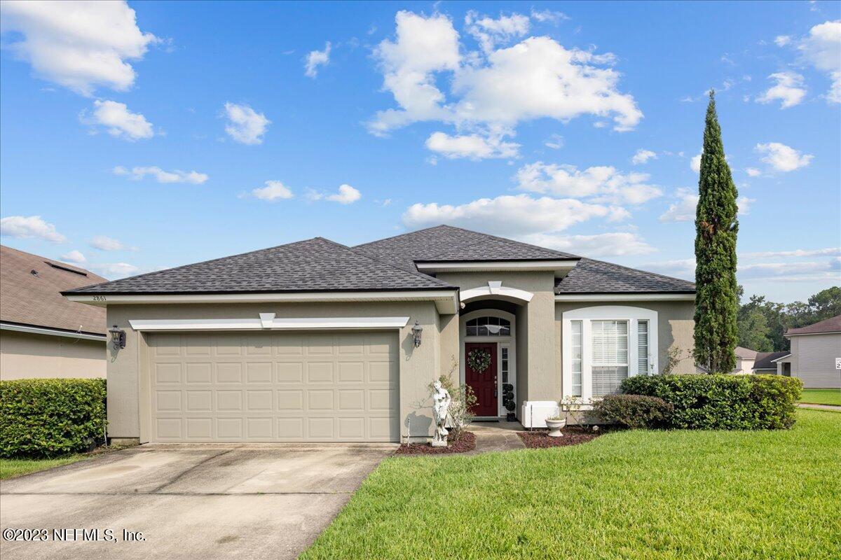 2861 Spoonbill Trail Orange Park, FL 32073 - Photo 1 of 23 a front view of a house with garden