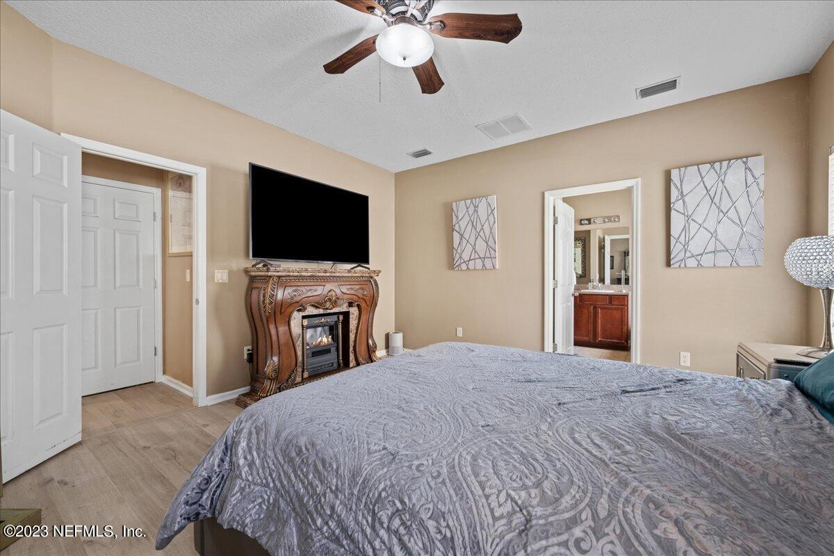 2861 Spoonbill Trail Orange Park, FL 32073 - Photo 17 of 23 a bedroom with a bed and a flat screen tv