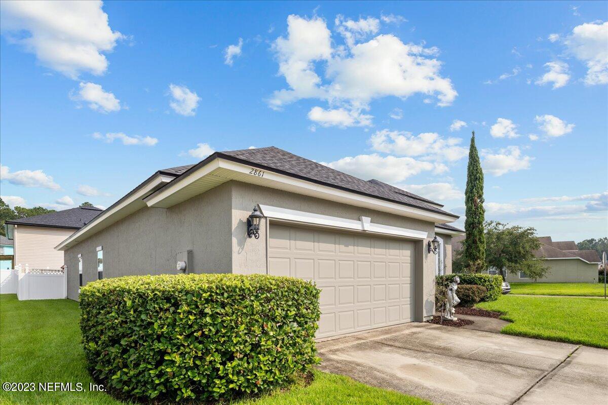2861 Spoonbill Trail Orange Park, FL 32073 - Photo 3 of 23 a front view of a house with garden