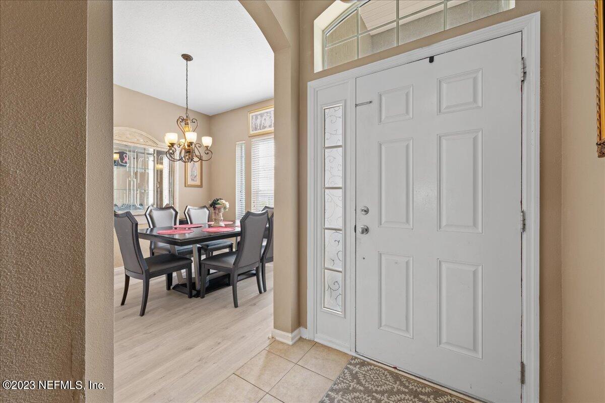 2861 Spoonbill Trail Orange Park, FL 32073 - Photo 5 of 23 a view of a dining room with furniture and chandelier