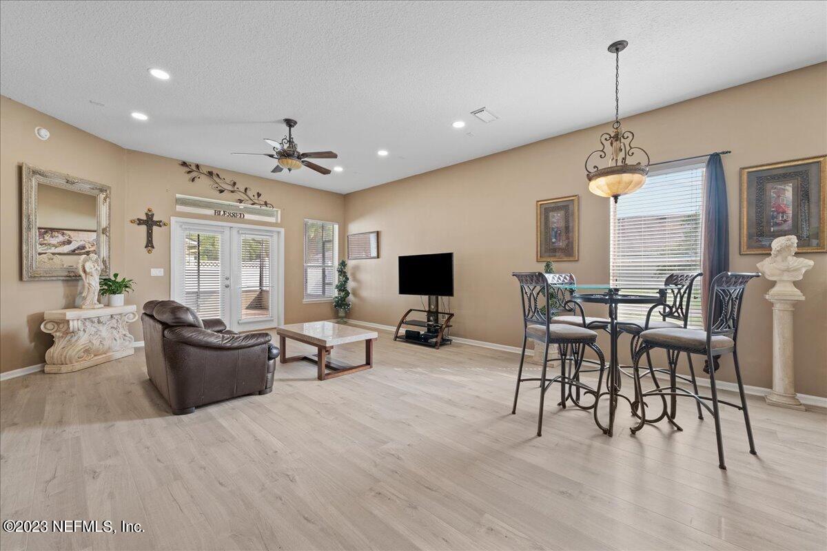 2861 Spoonbill Trail Orange Park, FL 32073 - Photo 6 of 23 a living room with furniture a flat screen tv and a large window