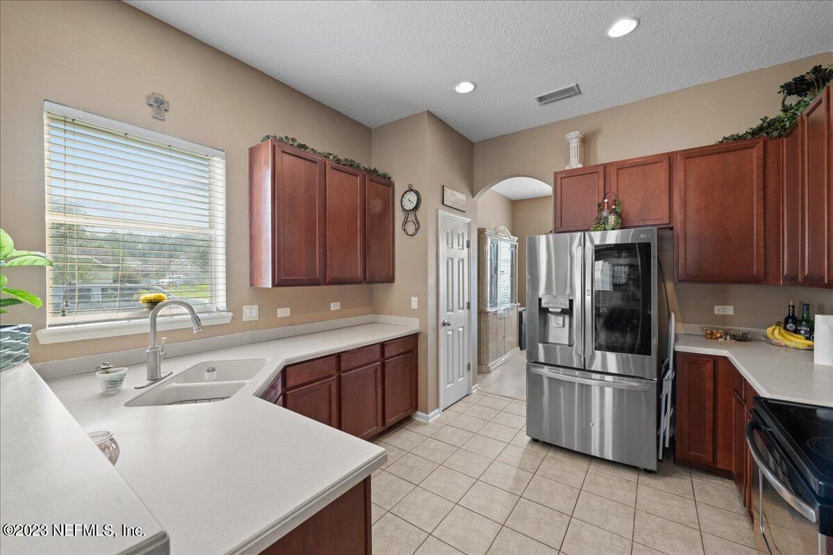 2861 Spoonbill Trail Orange Park, FL 32073 - Photo 9 of 23 a kitchen with a sink refrigerator and cabinets