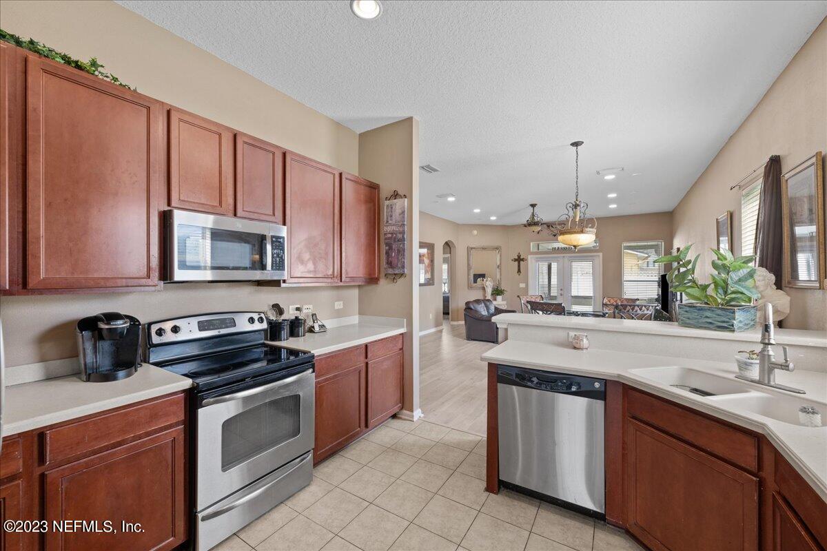 2861 Spoonbill Trail Orange Park, FL 32073 - Photo 10 of 23 a kitchen with stainless steel appliances a sink stove and microwave