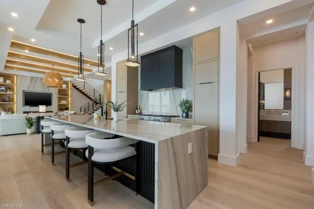 a kitchen with stainless steel appliances kitchen island a large island in the center