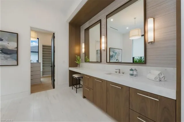 a bathroom with a double vanity sink and a mirror