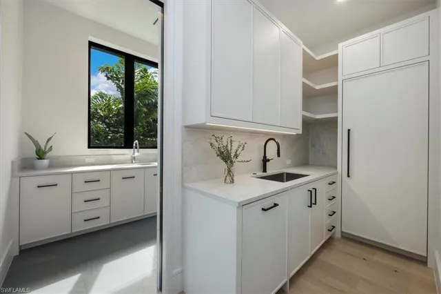 a view of cabinets a sink and a window