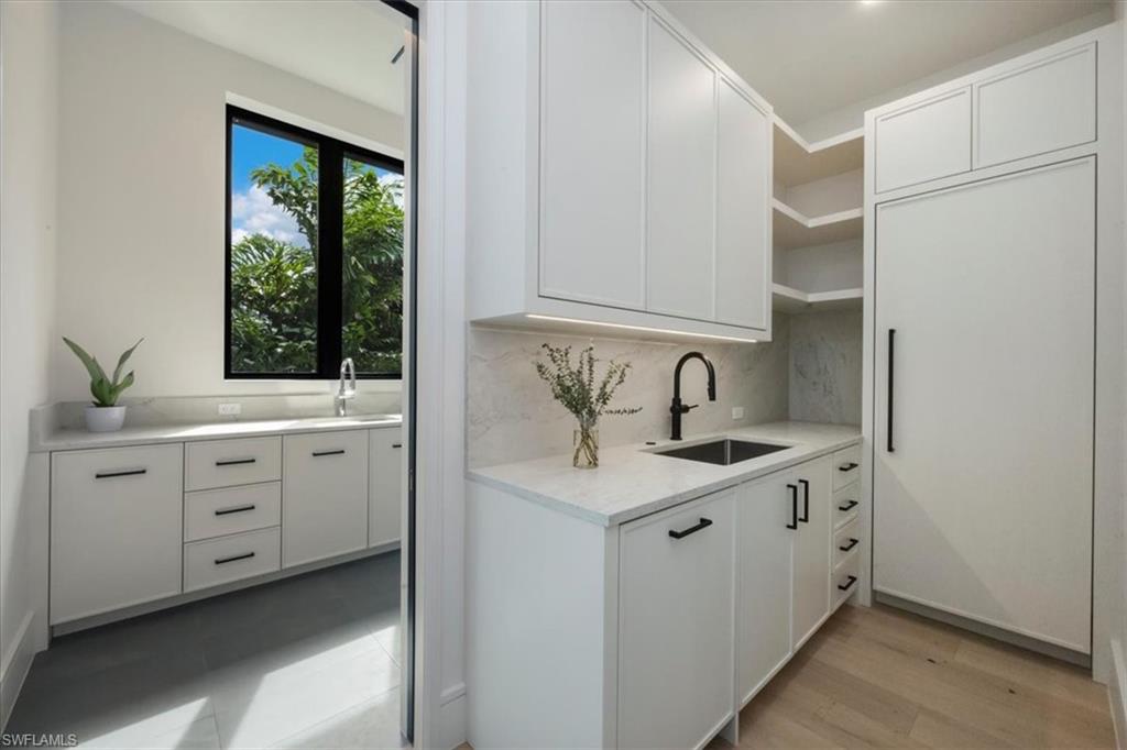 1640 Dolphin Court Naples, FL 34102 - Photo 25 of 45 a view of cabinets a sink and a window
