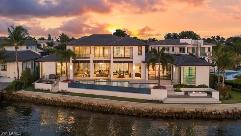 1640 Dolphin Court Naples, FL 34102 - Photo 28 of 45 a front view of a house with a lake view