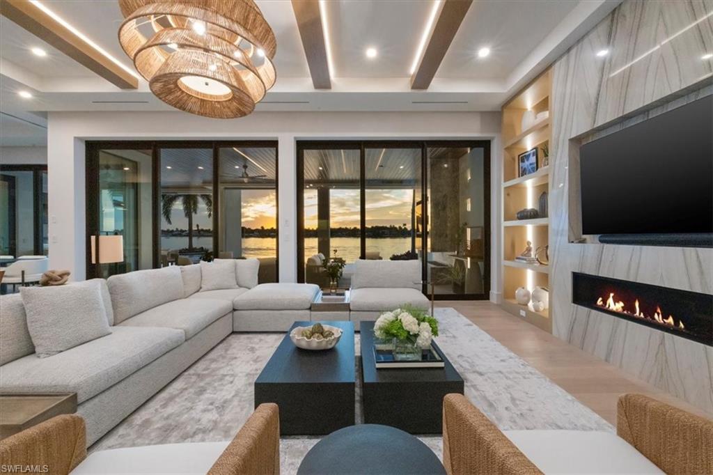 1640 Dolphin Court Naples, FL 34102 - Photo 3 of 45 a living room with furniture and a flat screen tv