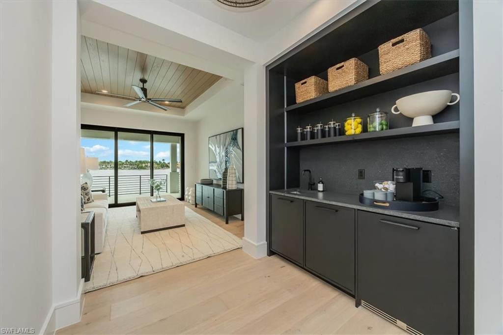 1640 Dolphin Court Naples, FL 34102 - Photo 35 of 45 a kitchen with stainless steel appliances granite countertop a sink and cabinets