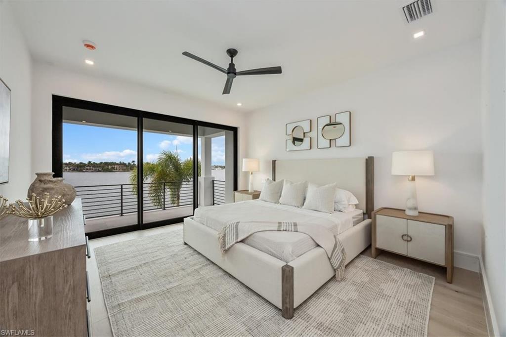 1640 Dolphin Court Naples, FL 34102 - Photo 37 of 45 a spacious bedroom with a bed and large window