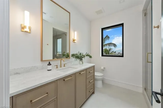 a living room with furniture and large windows