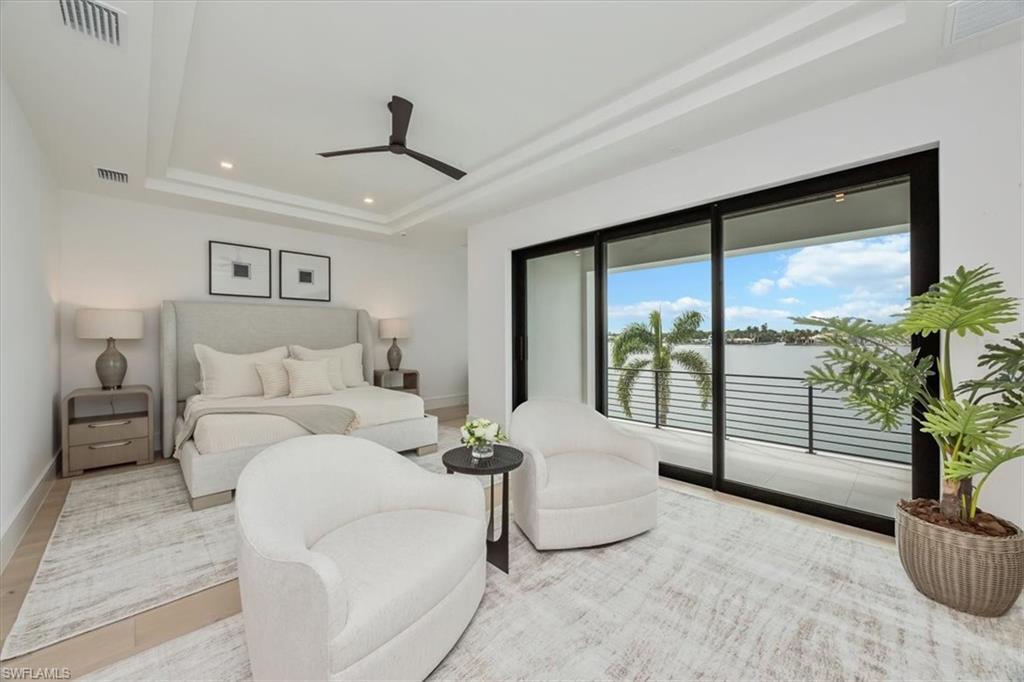 1640 Dolphin Court Naples, FL 34102 - Photo 39 of 45 a living room with furniture and large windows