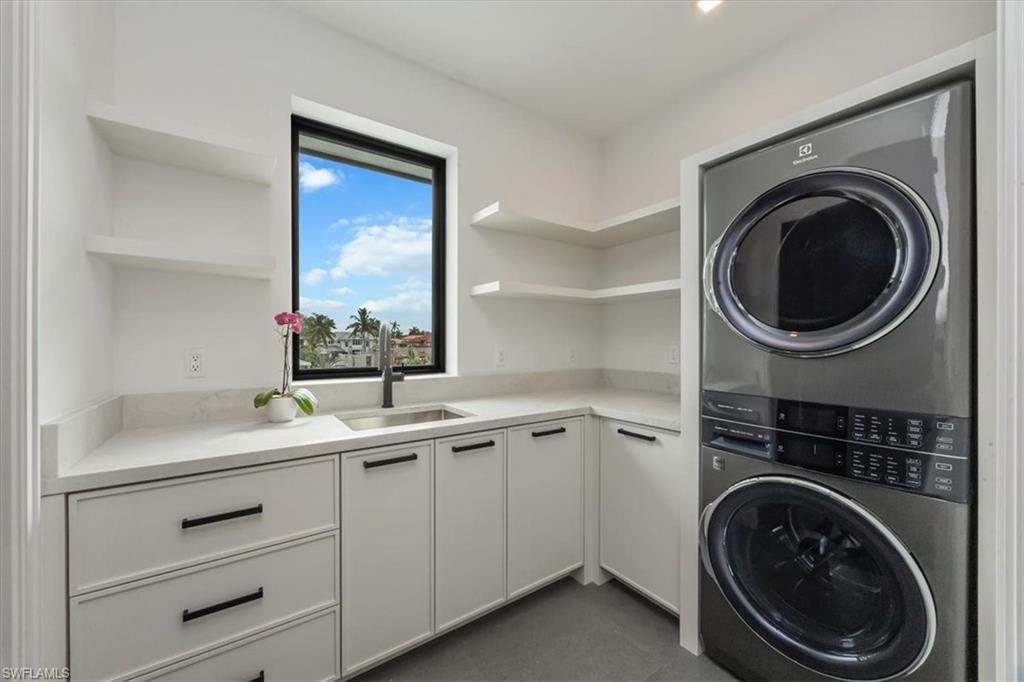 1640 Dolphin Court Naples, FL 34102 - Photo 42 of 45 a utility room with sink dryer and washer