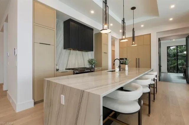 a kitchen with a table chairs refrigerator and microwave