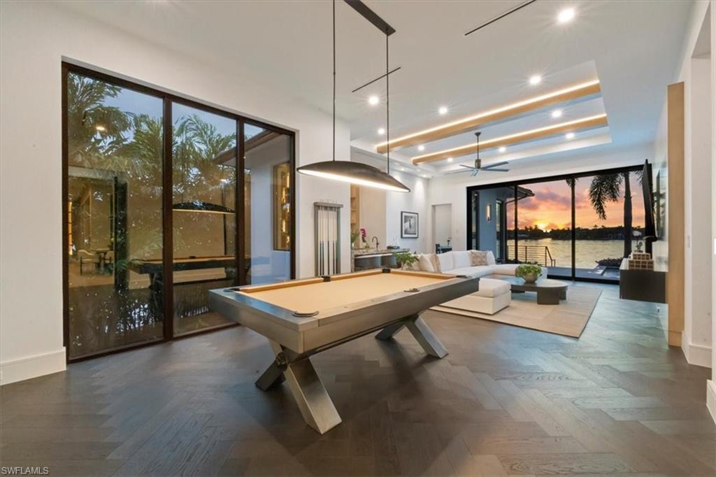 1640 Dolphin Court Naples, FL 34102 - Photo 7 of 45 a room with lots of furniture and a large window