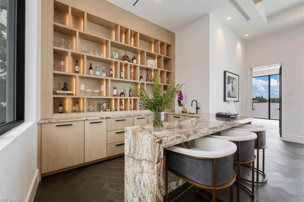 1640 Dolphin Court Naples, FL 34102 - Photo 10 of 45 a kitchen with a sink and chairs
