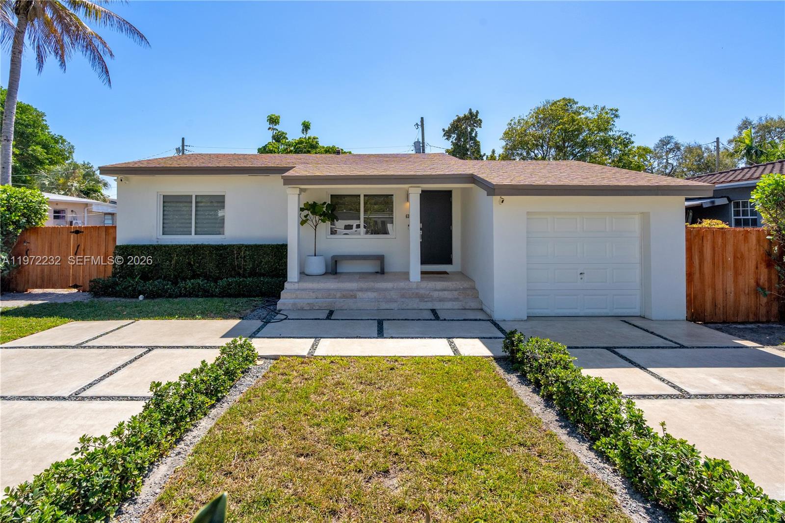 6376 Southwest 20th Street Miami, FL 33155 - Photo 1 of 42 a front view of a house with garden