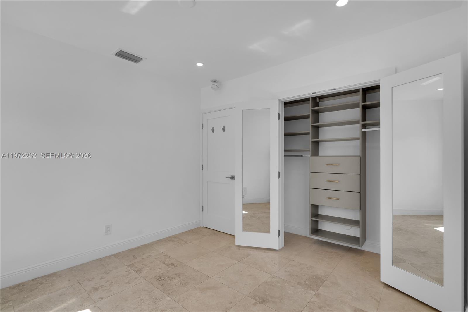 6376 Southwest 20th Street Miami, FL 33155 - Photo 19 of 42 a view of walk in closet with empty racks