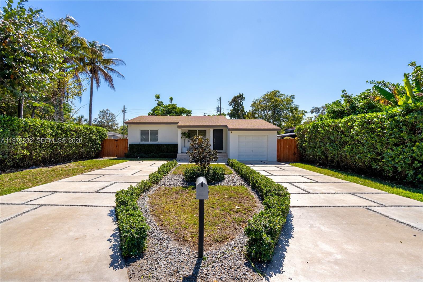 6376 Southwest 20th Street Miami, FL 33155 - Photo 2 of 42 a front view of a house with garden
