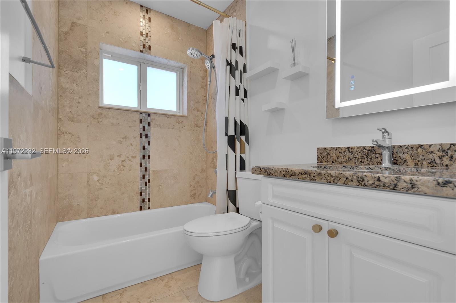 6376 Southwest 20th Street Miami, FL 33155 - Photo 23 of 42 a bathroom with a granite countertop sink a toilet and shower