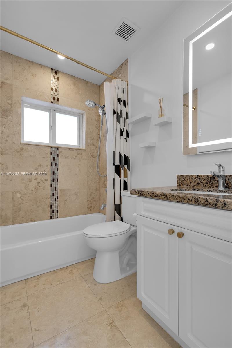 6376 Southwest 20th Street Miami, FL 33155 - Photo 24 of 42 a bathroom with a granite countertop sink a toilet and shower