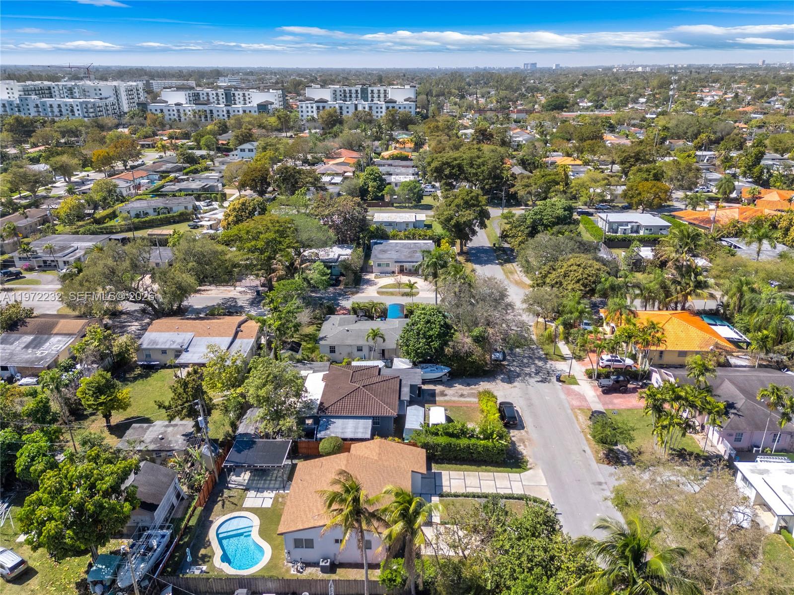 6376 Southwest 20th Street Miami, FL 33155 - Photo 39 of 42 an aerial view of a city with lots of residential buildings ocean and mountain view in back