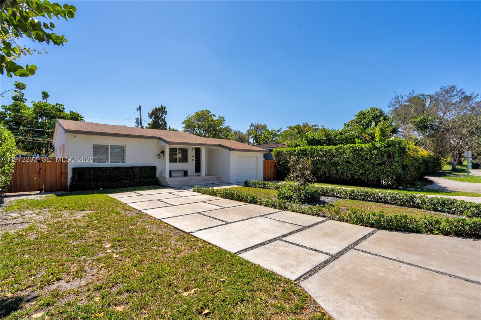 6376 Southwest 20th Street Miami, FL 33155 - Photo 4 of 42 a front view of a house with a yard and potted plants