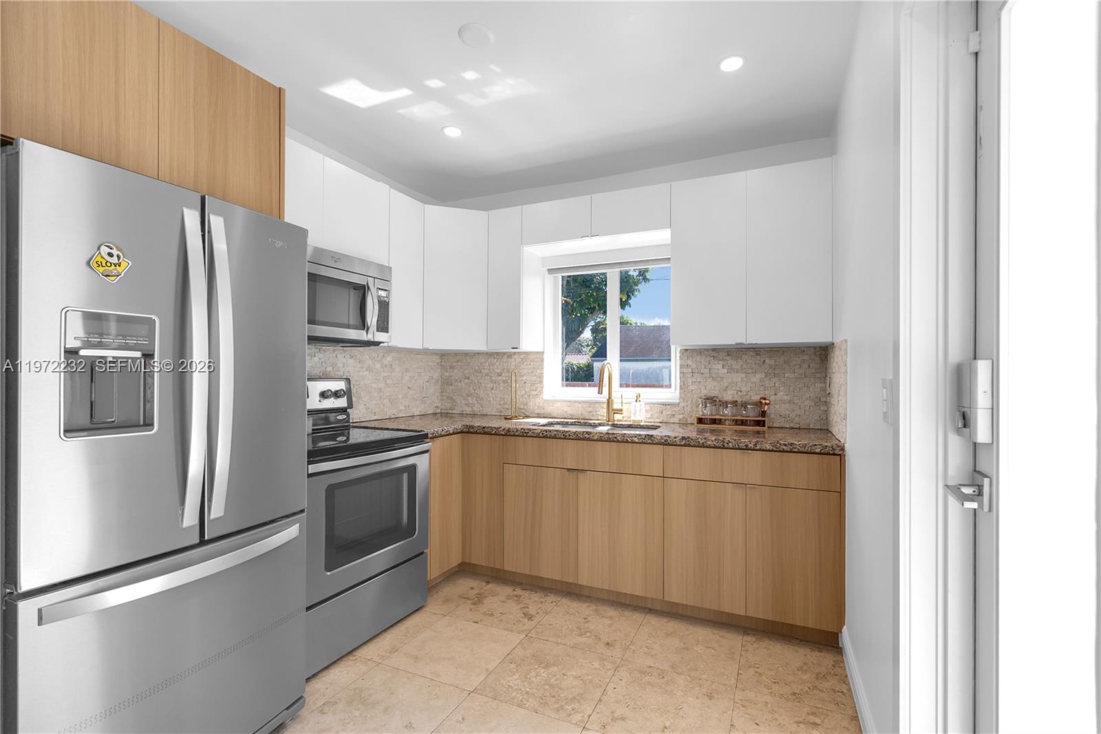 6376 Southwest 20th Street Miami, FL 33155 - Photo 6 of 42 a kitchen with stainless steel appliances granite countertop a sink stove and refrigerator