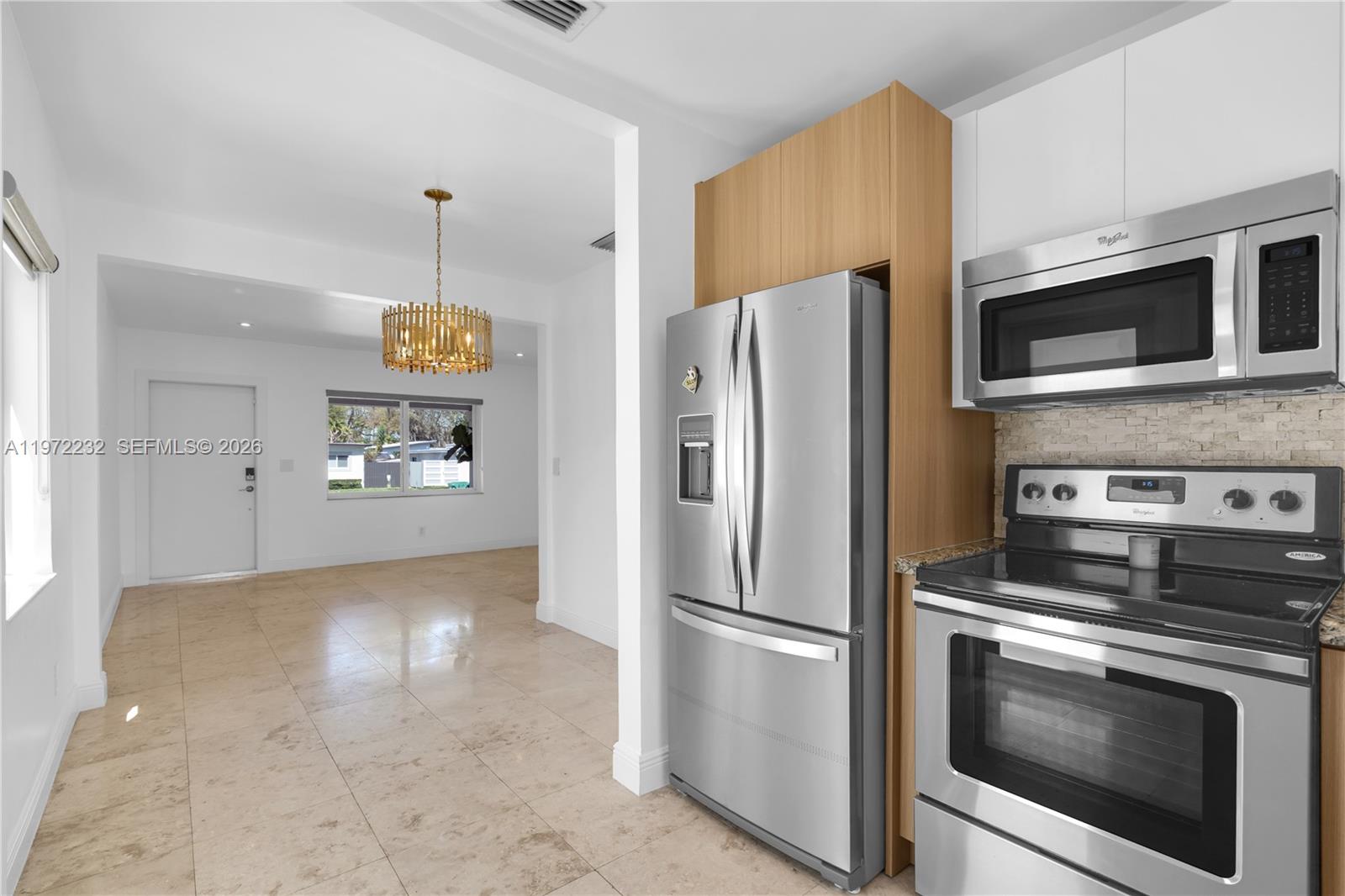 6376 Southwest 20th Street Miami, FL 33155 - Photo 7 of 42 a kitchen with stainless steel appliances a refrigerator a stove a microwave and cabinets