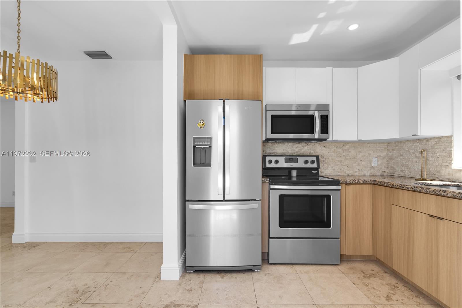 6376 Southwest 20th Street Miami, FL 33155 - Photo 9 of 42 a kitchen with stainless steel appliances granite countertop a refrigerator and a stove top oven