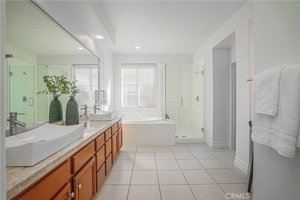 17 Mt Vernon Irvine, CA 92620 - Photo 14 of 25 a spacious bathroom with a double vanity sink a large mirror and a bathtub