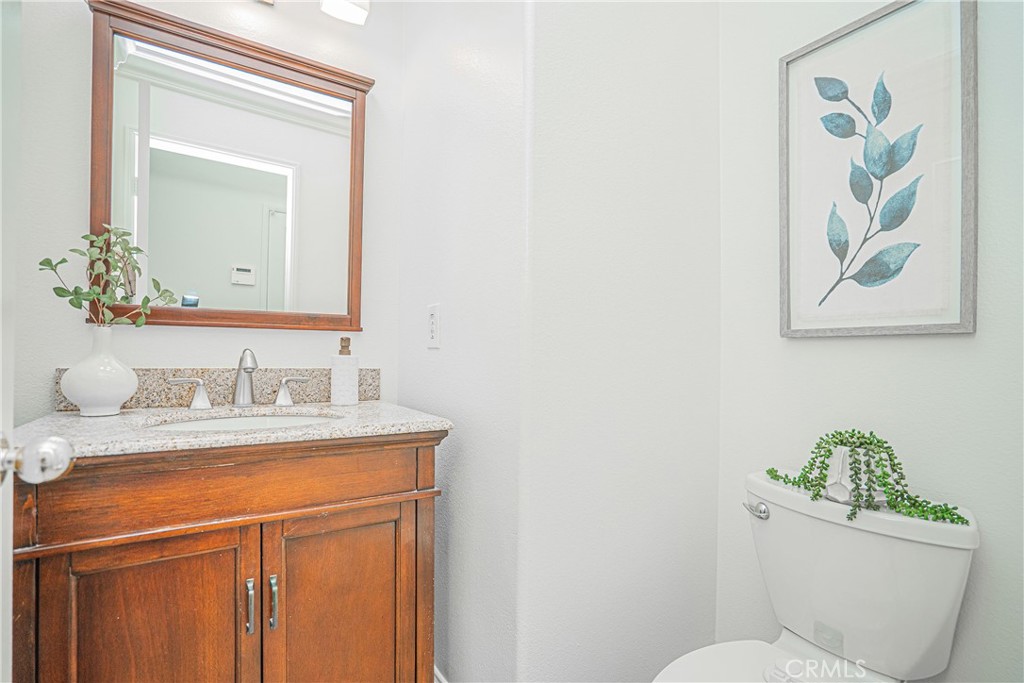 17 Mt Vernon Irvine, CA 92620 - Photo 9 of 25 a bathroom with a granite countertop toilet a sink and mirror