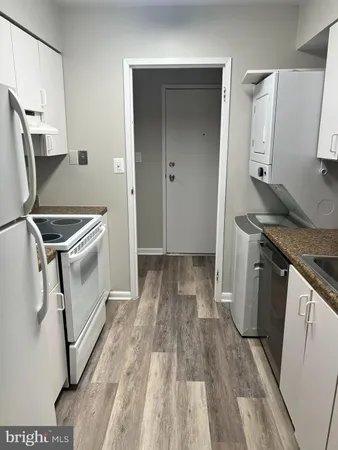 a view of a kitchen with a sink and wooden floor