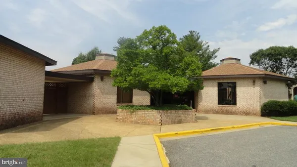 a front view of a house with yard and garage