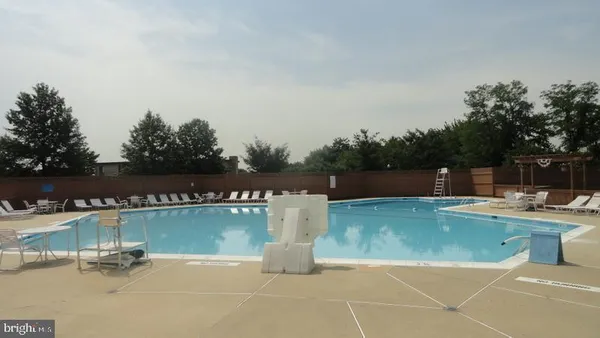 a view of a swimming pool and lounge chairs