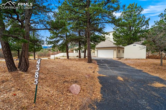 4385 Sandstone Road Monument, CO 80132 - Photo 4 of 50 View of front facade with a garage, stucco siding, and asphalt driveway