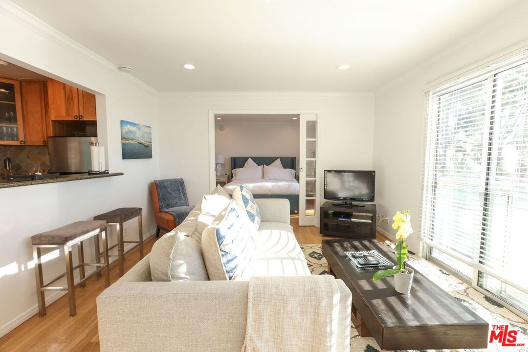 2101 Ocean Avenue, Unit 1 Santa Monica, CA 90405 - Photo 6 of 11 a living room with furniture and a flat screen tv