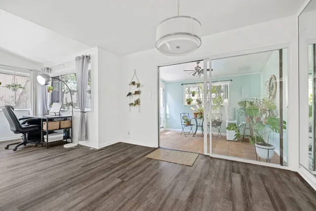 a view of empty room with wooden floor
