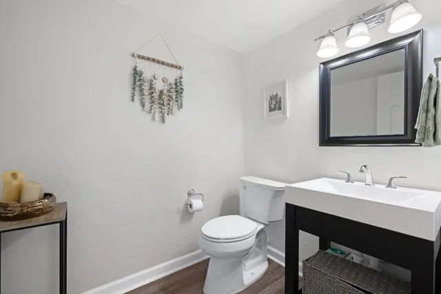 a bathroom with a toilet a sink and mirror