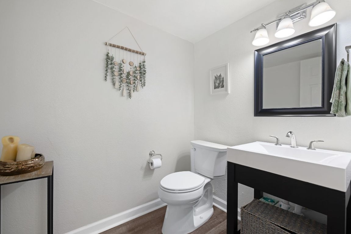 8906 Trone Circle, Unit A Austin, TX 78758 - Photo 19 of 33 a bathroom with a toilet a sink and mirror
